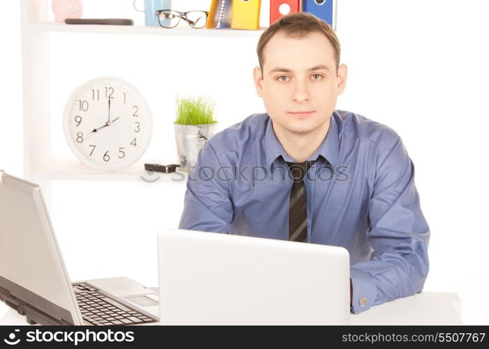 bright picture of businessman with laptop computer in office