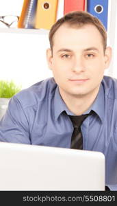 bright picture of businessman with laptop computer in office