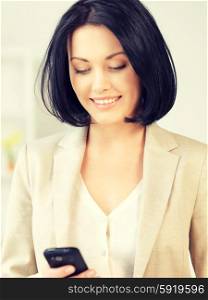 bright picture of businesswoman with cell phone. businesswoman with cell phone