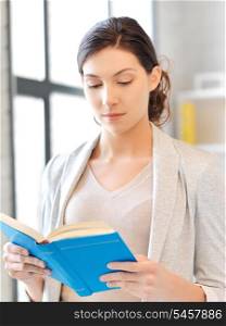 bright picture of calm and serious woman with book