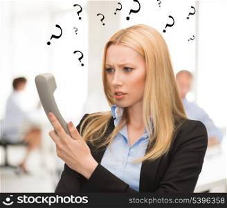 bright picture of confused woman with phone in office