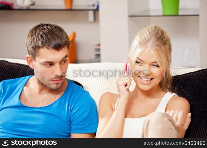 bright picture of couple with cellphone (focus on woman)