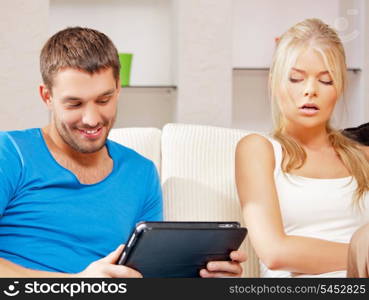 bright picture of couple with tablet PC (focus on man)