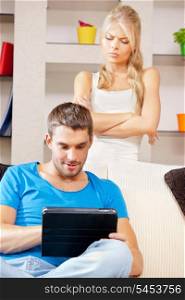 bright picture of couple with tablet PC (focus on man)