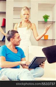 bright picture of couple with tablet PC (focus on man)