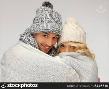 bright picture of family couple under warm blanket (focus on man)