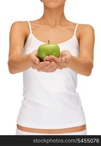bright picture of female hands with green apple