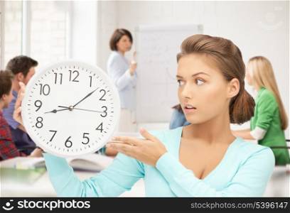 bright picture of girl holding big clock at school