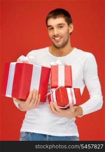 bright picture of handsome man holding many gift boxes.