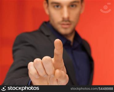 bright picture of handsome man in suit pressing virtual button.