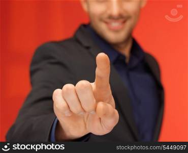 bright picture of handsome man in suit pressing virtual button.