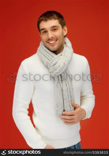bright picture of handsome man in warm sweater and scarf.