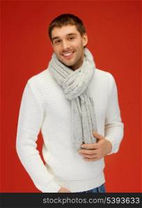 bright picture of handsome man in warm sweater and scarf.