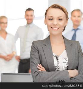 bright picture of happy and smiling woman in office