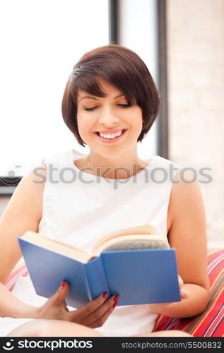 bright picture of happy and smiling woman with book