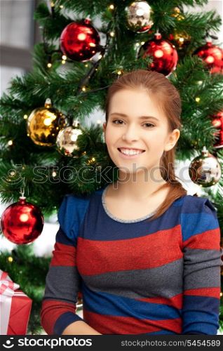 bright picture of happy and smiling woman with christmas tree...