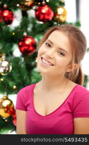 bright picture of happy and smiling woman with christmas tree