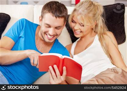 bright picture of happy couple with book (focus on man)