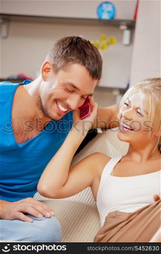 bright picture of happy couple with cellphone (focus on woman)