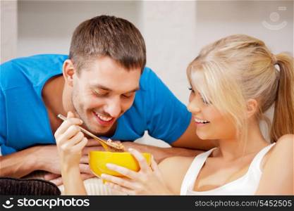 bright picture of happy couple with muesli (focus on man)