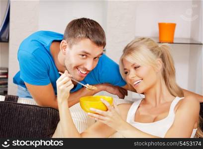 bright picture of happy couple with muesli (focus on woman)