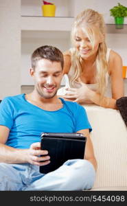 bright picture of happy couple with tablet PC (focus on man)