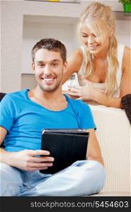 bright picture of happy couple with tablet PC (focus on man)