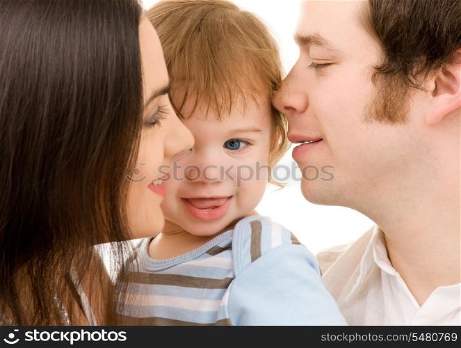 bright picture of happy family over white (focus on baby)
