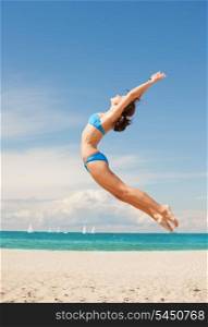 bright picture of happy jumping woman on the beach.