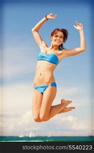 bright picture of happy jumping woman on the beach