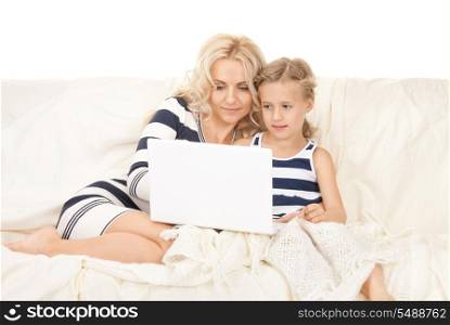 bright picture of happy mother and child with laptop computer&#xA;