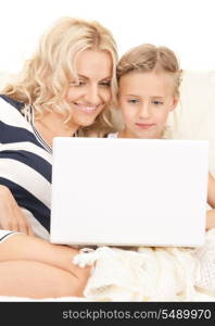 bright picture of happy mother and child with laptop computer&#xA;