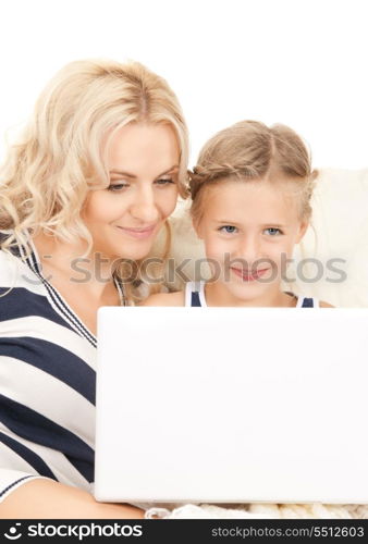 bright picture of happy mother and child with laptop computer&#xA;