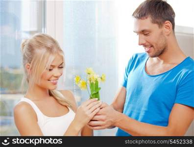 bright picture of happy romantic couple with flowers (focus on woman)