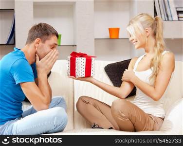 bright picture of happy romantic couple with gift (focus on man)