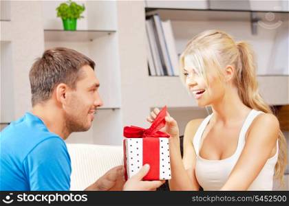 bright picture of happy romantic couple with gift (focus on woman)
