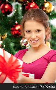 bright picture of happy woman with gift box and christmas tree