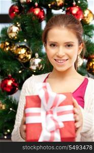 bright picture of happy woman with gift box and christmas tree