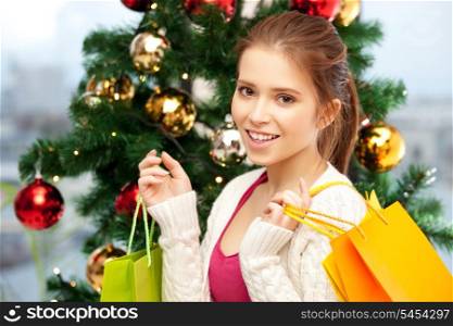 bright picture of happy woman with shopping bags and christmas tree.....