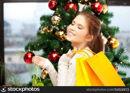 bright picture of happy woman with shopping bags and christmas tree.....
