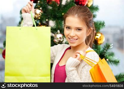bright picture of happy woman with shopping bags and christmas tree