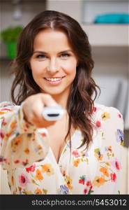 bright picture of happy woman with TV remote