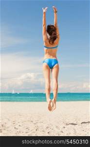 bright picture of jumping woman on the beach.