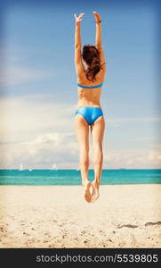 bright picture of jumping woman on the beach