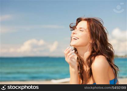 bright picture of laughing woman on the beach.