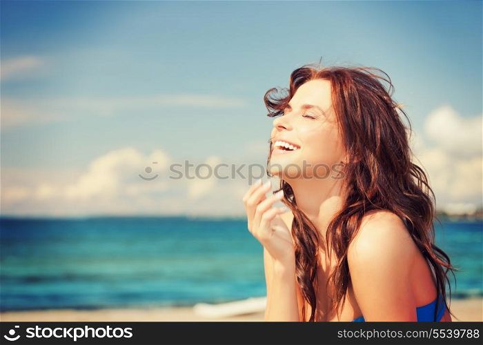 bright picture of laughing woman on the beach
