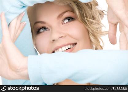 bright picture of lovely blonde creating a frame with hands