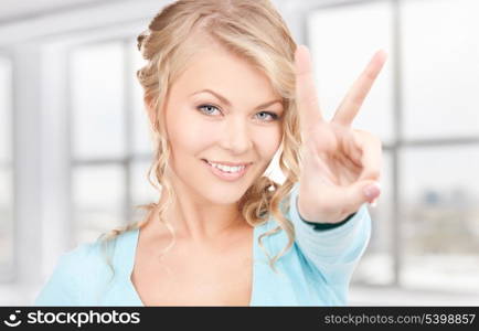 bright picture of lovely blonde showing victory sign