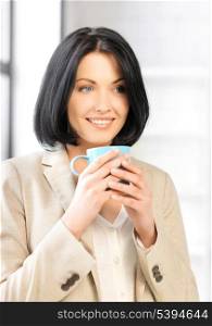 bright picture of lovely businesswoman with mug.