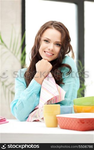 bright picture of lovely housewife at the kitchen